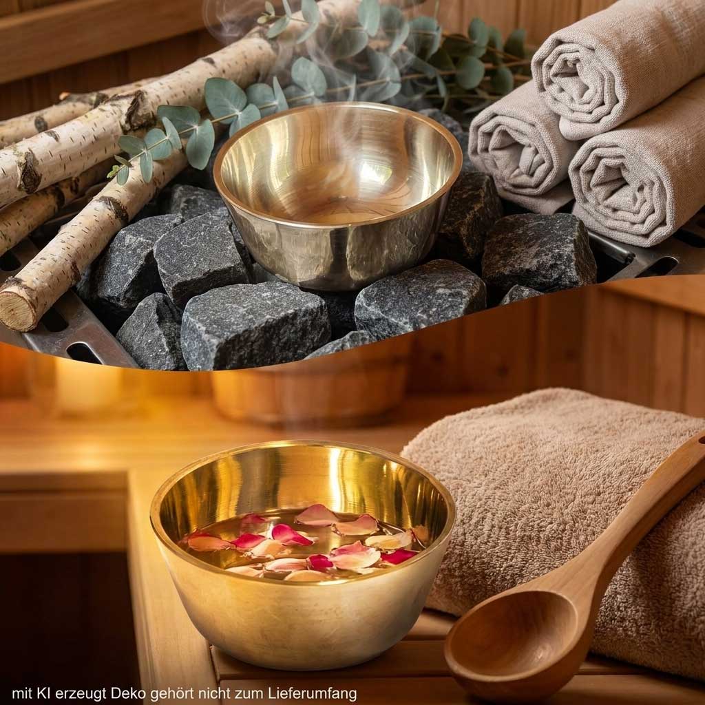 Eine kleine metallische Sauna-Verdunstungsschale, die auf heißen, dunklen Saunasteinen platziert ist.